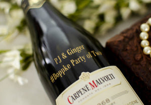 Bottle of Carpene Malvolti wine with decorative elements in the background